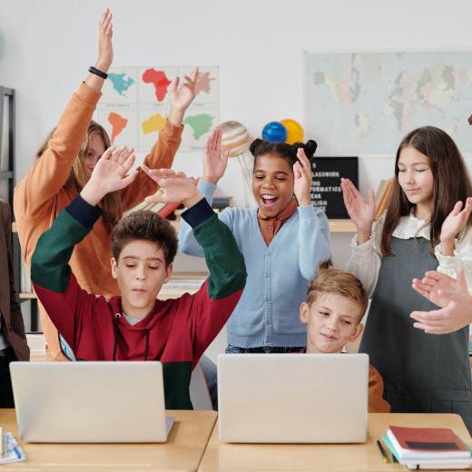 Group of students celebrating a learning achievement during ABA therapy in Chattanooga, fostering teamwork, social skills, and confidence in an inclusive classroom setting.