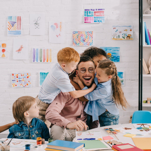 Smiling therapist engaging with children during ABA therapy in Chattanooga, fostering social skills, emotional growth, and positive learning experiences in a supportive environment.
