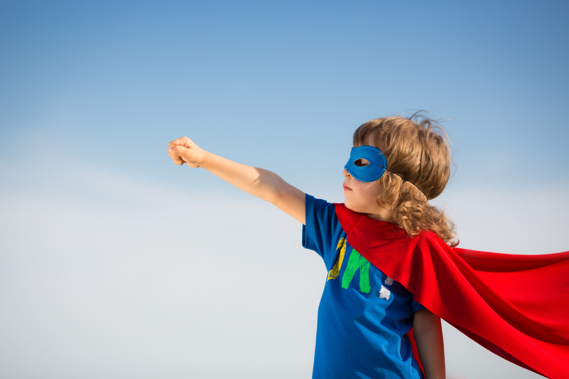 Child dressed as a superhero, demonstrating confidence and imagination, highlighting the impact of autism social skills development in fostering self-expression and independence.